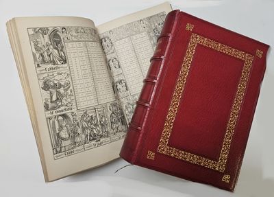 a red book that is open on a white table