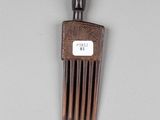 a wooden comb that has a tag on it