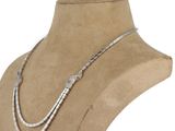 a close up of a mannequin with a necklace on it