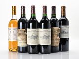 six bottles of wine are lined up on a white surface