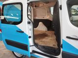 a white van with a blue stripe parked in a parking lot