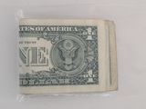 a close up of a one dollar bill on a white surface