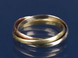 un gros plan d'une bague en or et en argent sur un fond bleu