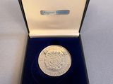 an image of a silver coin in a black box