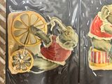 four magnets on the back of a suitcase that have pictures of animals on them
