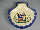 a blue and white plate with a picture of two people on it