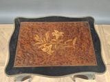 a wooden table with a floral design on it