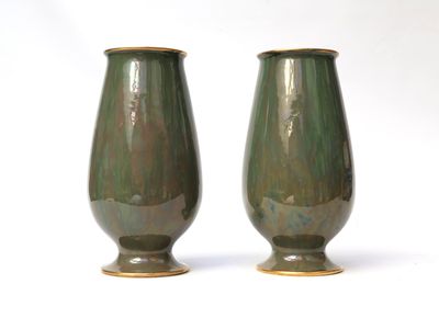 two vases that are sitting on a white surface