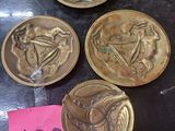 several gold coins are on top of a table with a pink sticker