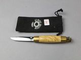 a knife that is laying on a table next to a pouch