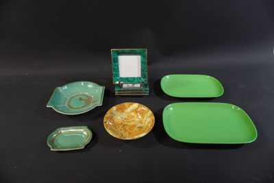 green and yellow dishes and a picture frame on a black table