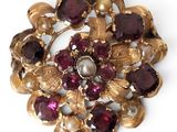 an image of a gold brooch with garnets and pearls