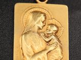 a gold plated pendant with a picture of the virgin and child