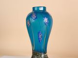 a blue vase sitting on top of a white table