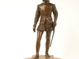 statue en bronze représentant un homme en costume, muni d'une canne