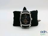 a watch that is sitting on top of a black pillow