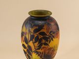 a vase that is sitting on a stand on a white surface