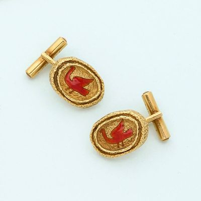 pair of gold and red enamel cufflinks with a bird on a branch