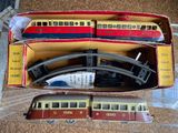 two toy trains in a box on the floor