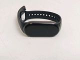 a close up of a black smart watch on a white surface