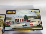 a box with a model of a gas station and a model of a car