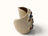 a picture of a ring with multi colored stones on it
