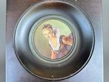 a plate with a picture of a woman and a cat on it