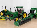 three toy tractors that are sitting on a table
