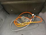an orange cord in the trunk of a car