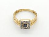 a yellow gold ring with a blue stone and diamonds