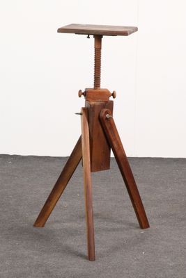 a small wooden stool with a wooden seat on top of it