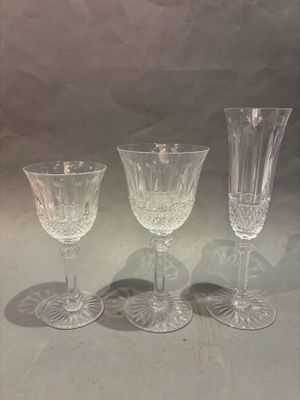 three clear wine glasses sitting on top of a table next to each other