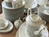 a table with a lot of dishes and cups on it