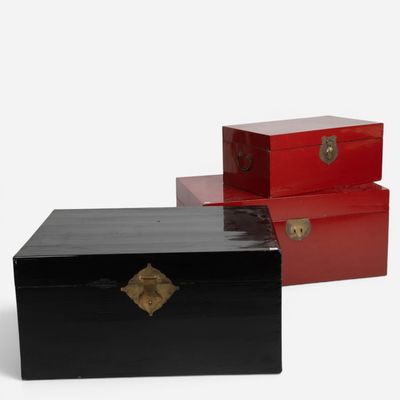 two black and red boxes sitting next to each other on a white surface
