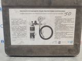 a sign on the side of a metal container with a pressure gauge on it