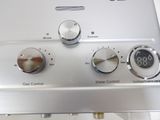 a close up of a gas stove with the controls on