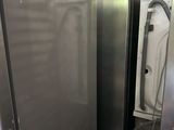 two refrigerators that are next to each other in a room