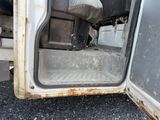 a close up of a truck door with a pillow in it