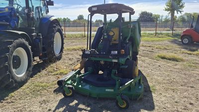 two tractors that are parked next to each other in the field