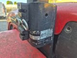 a close up of a red truck with a chain on it