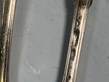 two spoons that are sitting next to each other