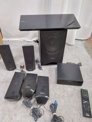a lot of different speakers and remotes on the floor