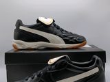 a pair of black and white puma trainers on a box