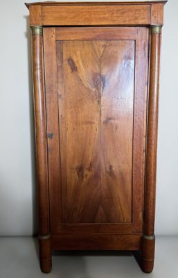 a wooden cabinet with a mirror on top of it