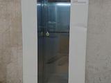 an image of a white refrigerator in a dirty room