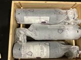 two bottles of wine in a wooden box on a table