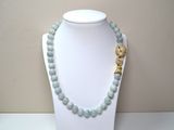 beaded necklace with a gold elephant charm on a white mannequin