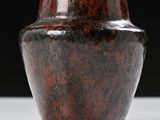 a brown vase sitting on a white table