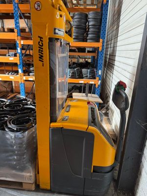a fork lift truck that is parked in a warehouse