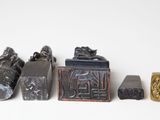 five different types of stone and metal items on a white surface